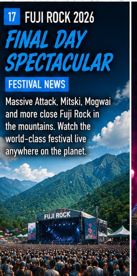 Fuji Rock Festival stage illuminated amidst the Naeba mountains in Japan.